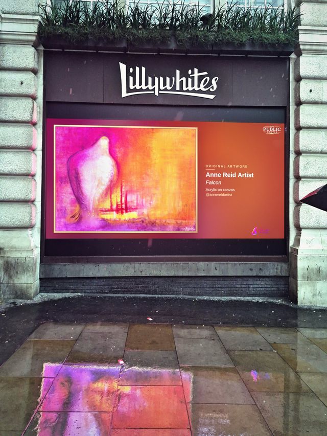 Falcon by Anne Reid on the Lillywhites screen, reflected in the wet pavement